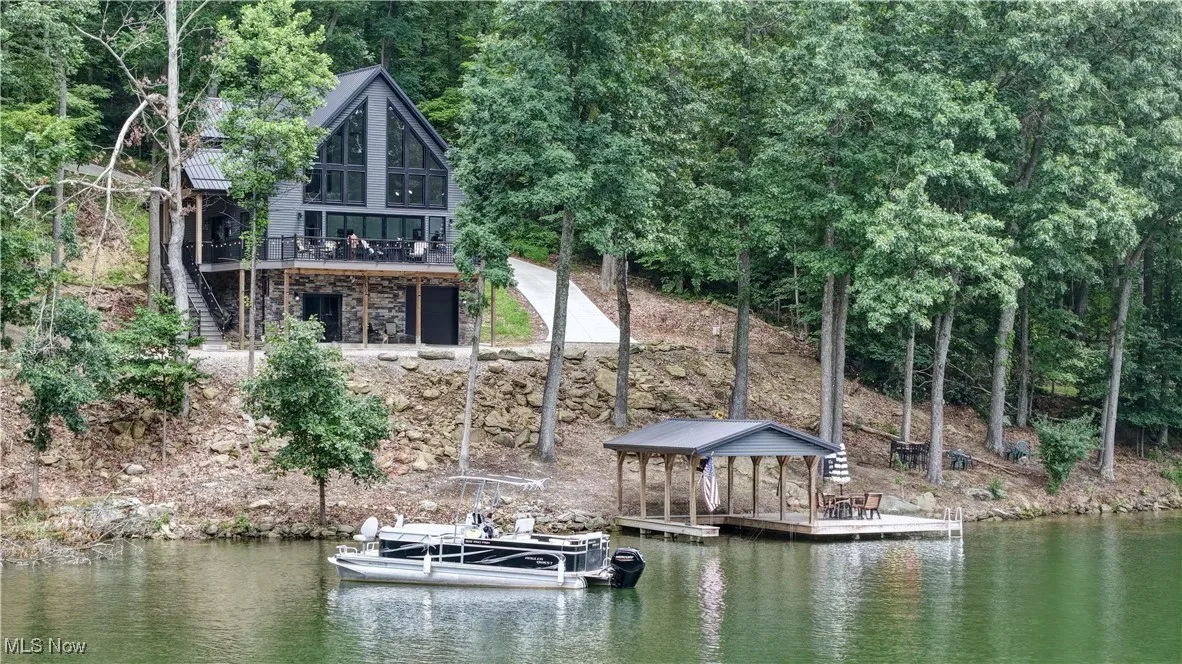 Dock featuring stairs and a deck with water view