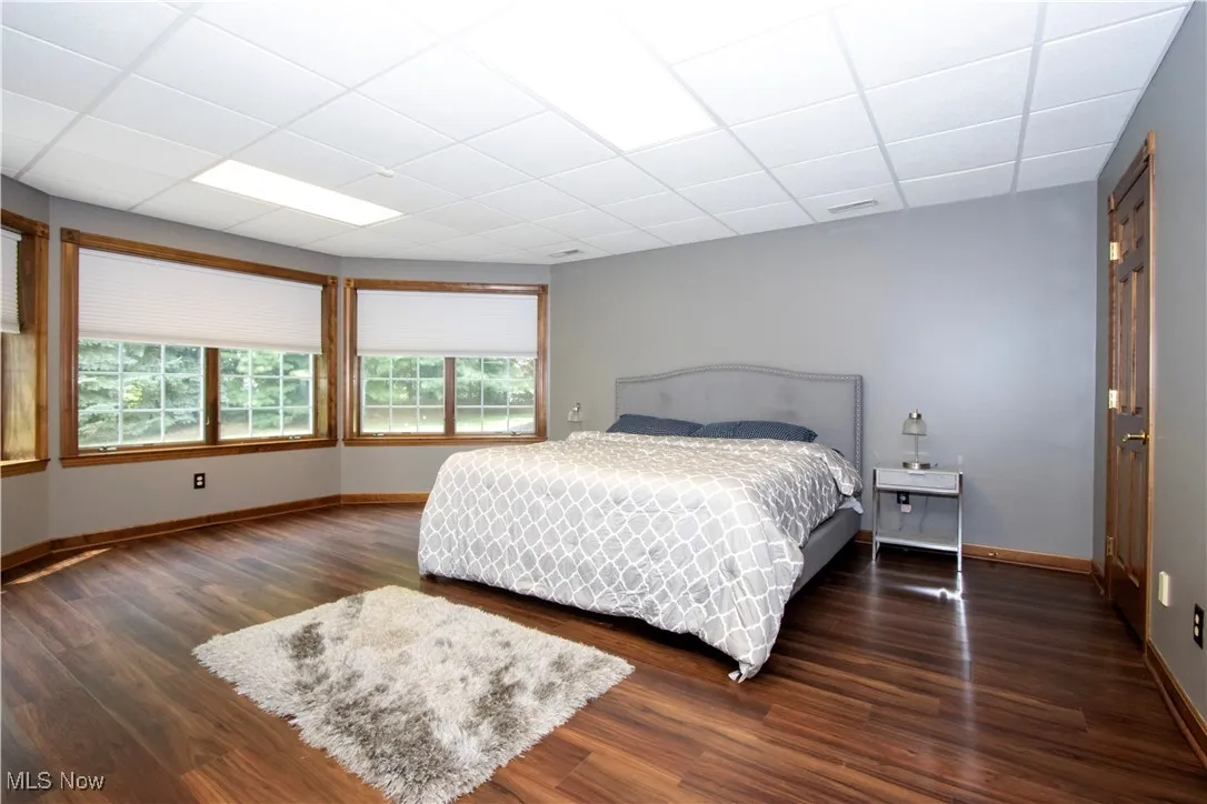 Bedroom in lower level  featuring wood finished floors and a paneled ceiling