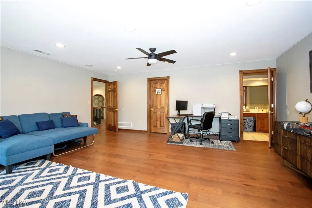Living room featuring light wood-style floors, an office area, recessed lighting, and ceiling fan