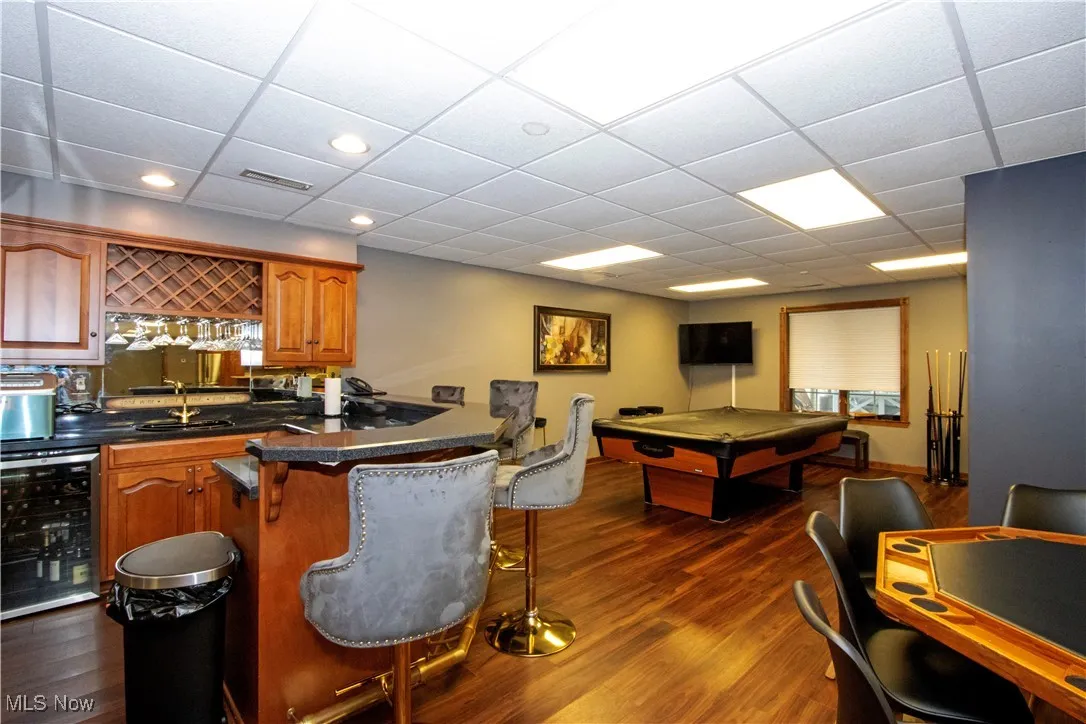 Playroom featuring beverage cooler, wet bar, pool table, dark wood-style flooring, and recessed lighting