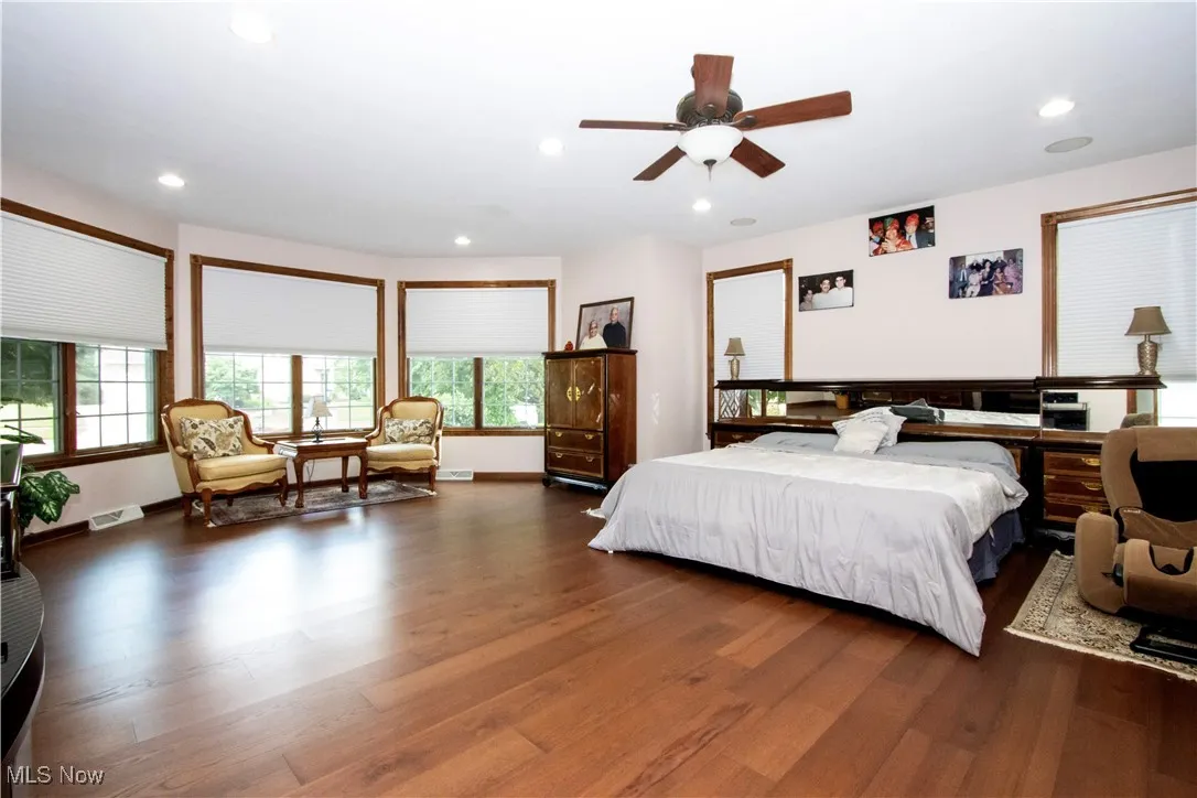 First floor Bedroom featuring dark wood finished floors and recessed lighting