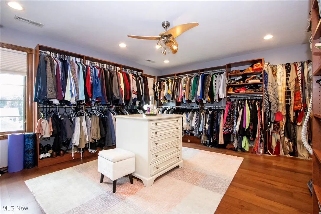 Spacious closet with ceiling fan