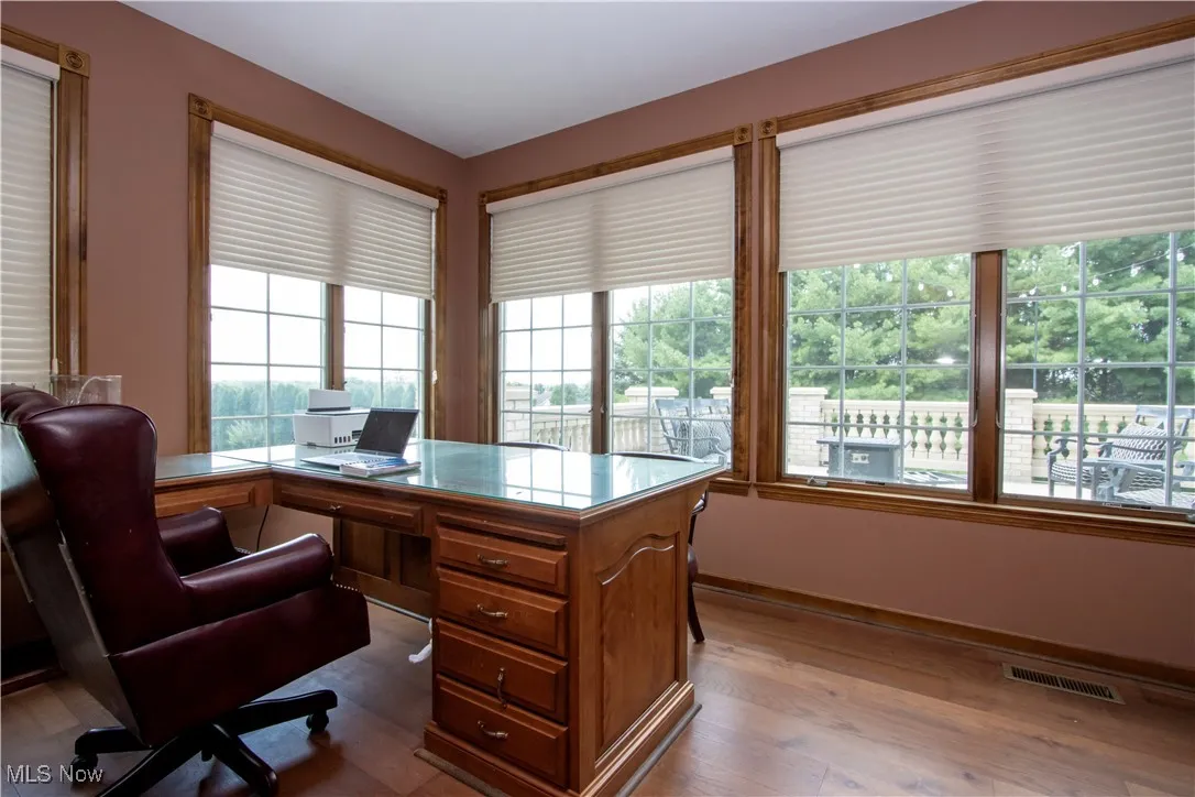 Office space with wood finished floors and baseboards