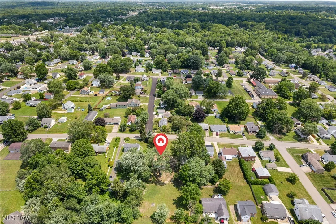 Aerial perspective of suburban area with a heavily wooded area
