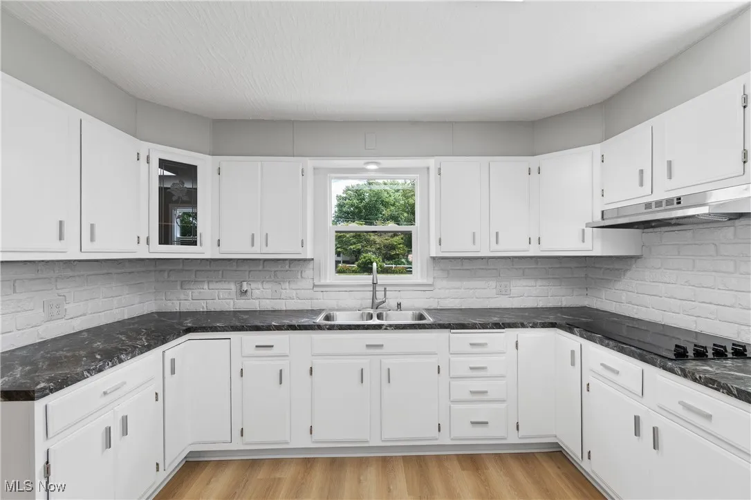 Kitchen with backsplash and white cabinets