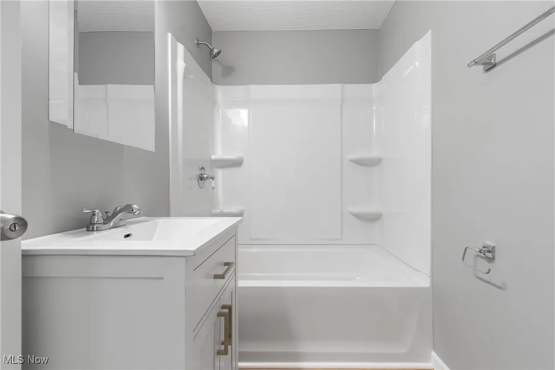 Bathroom featuring vanity and bathtub / shower combination