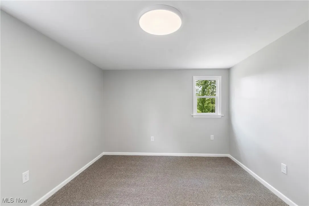 Carpeted bedroom with baseboards