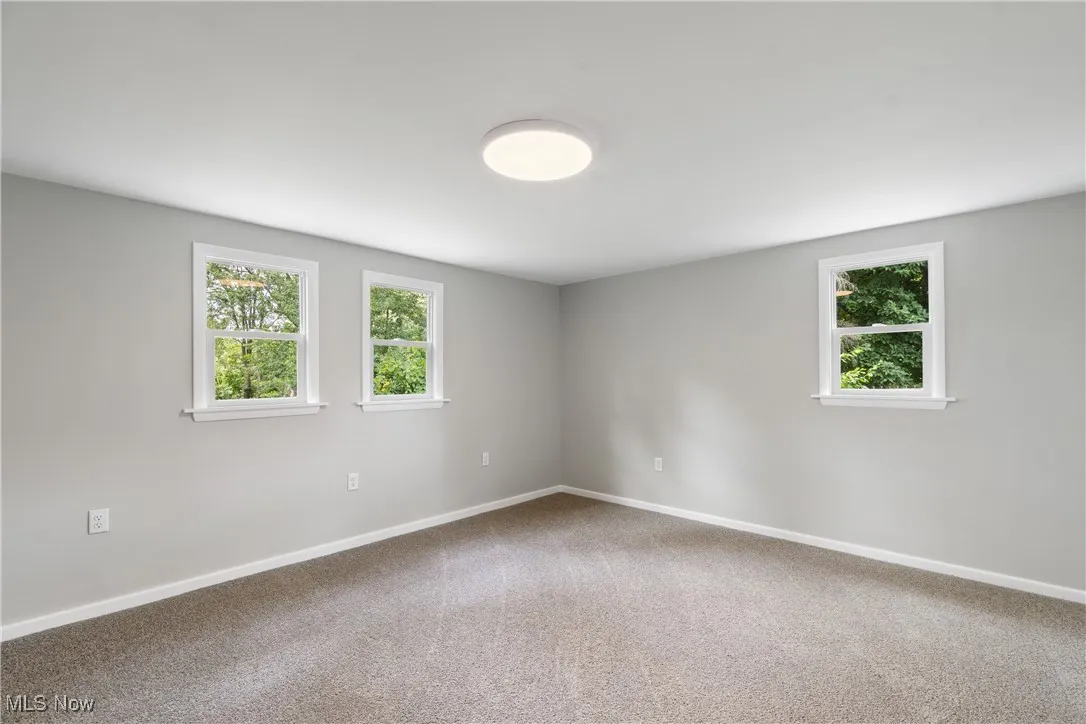 Bedroom featuring baseboards and carpet floors