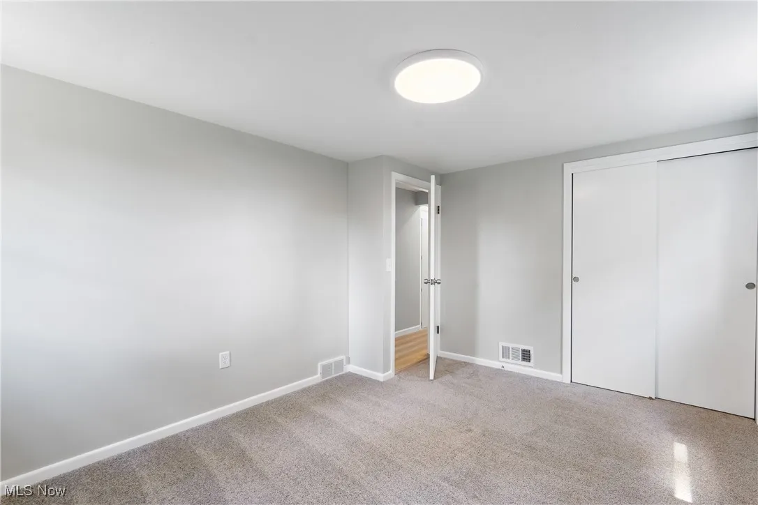 Unfurnished bedroom featuring a closet and carpet flooring