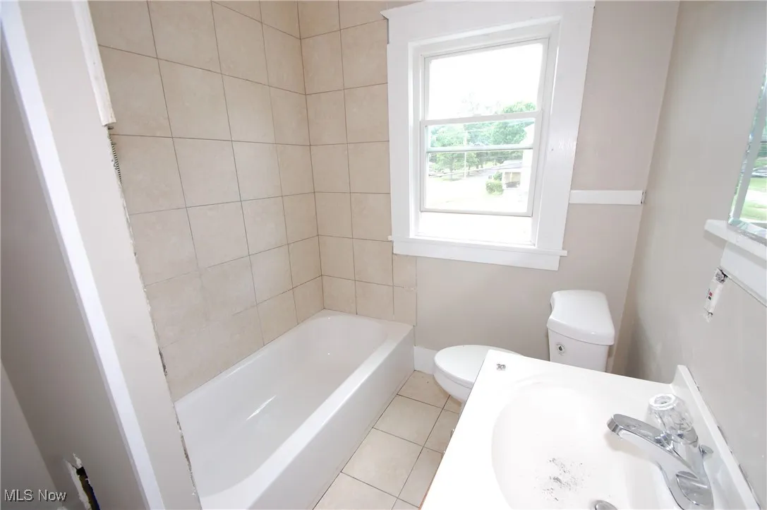 Bathroom with toilet and tile patterned floors