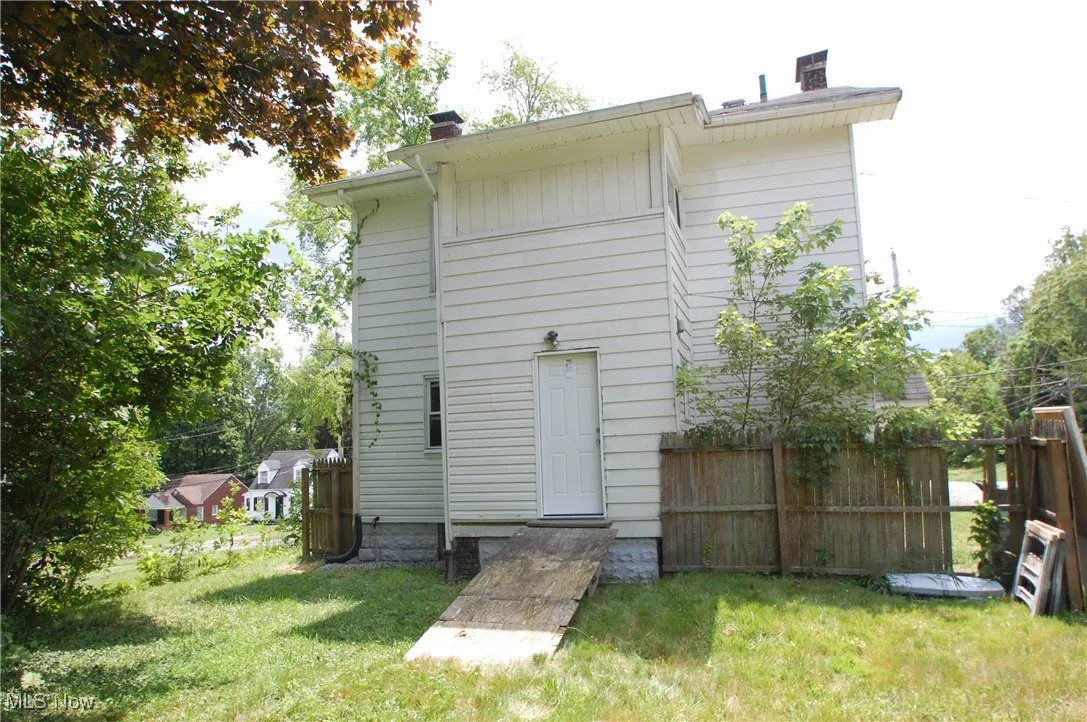Rear view of property with a chimney