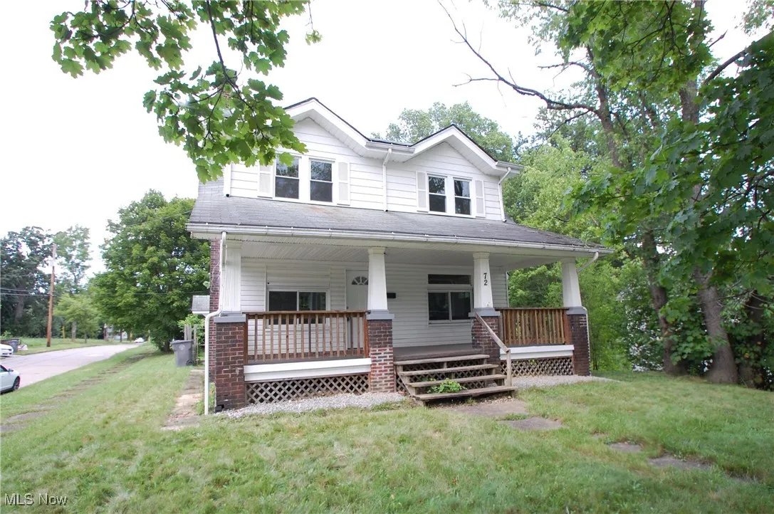 View of front of home featuring covered porch and a front lawn