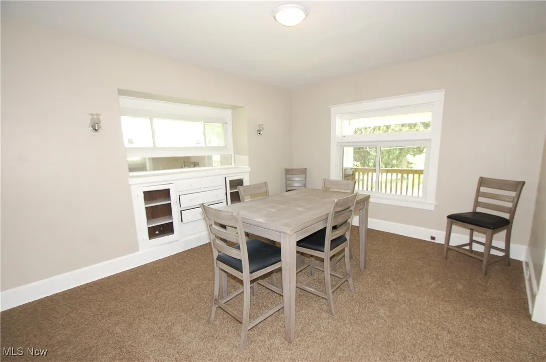 Dining room with baseboards and carpet floors