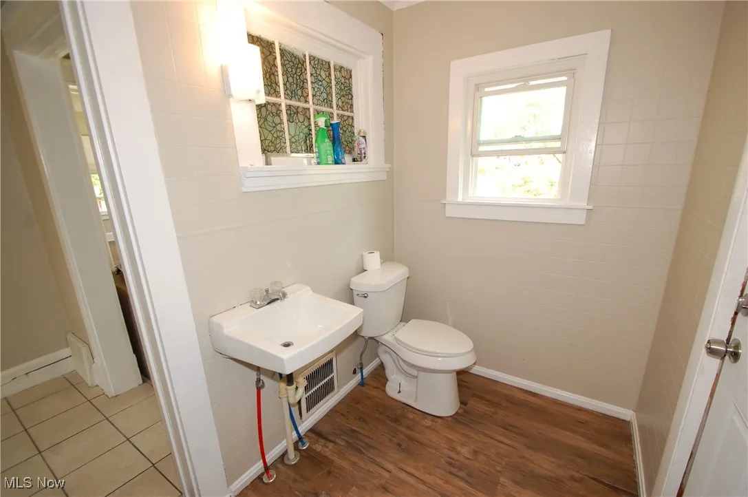 Bathroom featuring toilet and wood finished floors