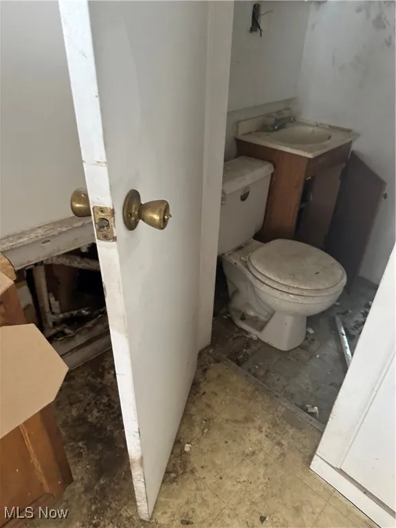 Half bathroom featuring toilet and a sink