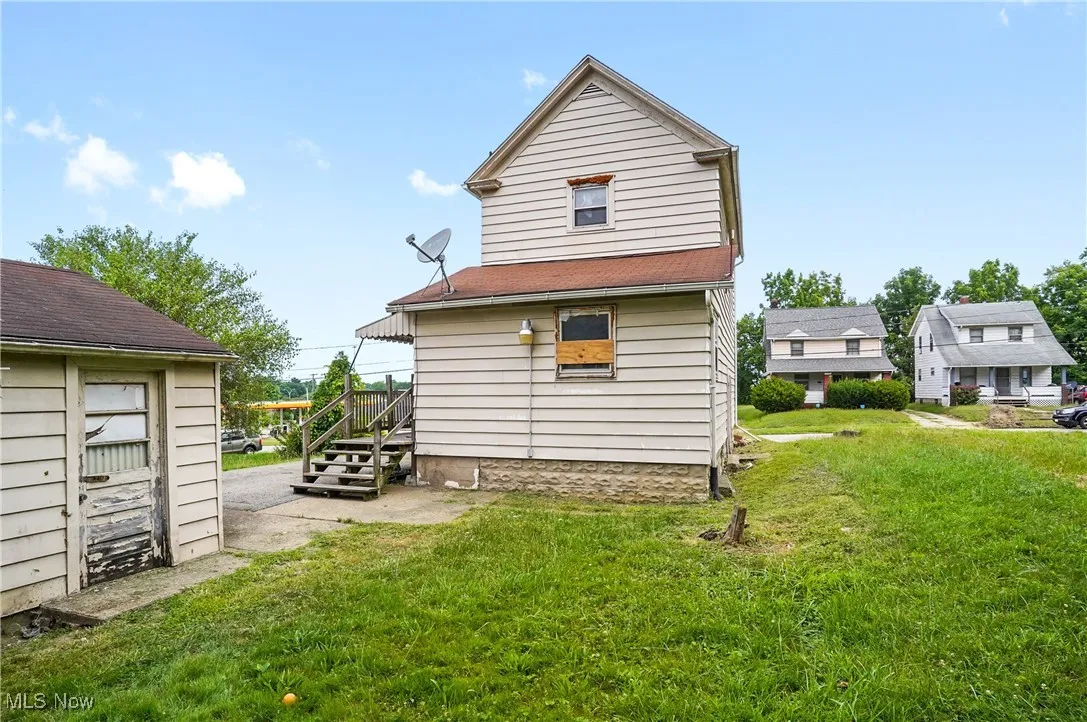 Rear view of property featuring a lawn