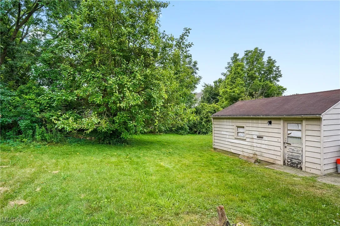 View of green lawn with an outbuilding