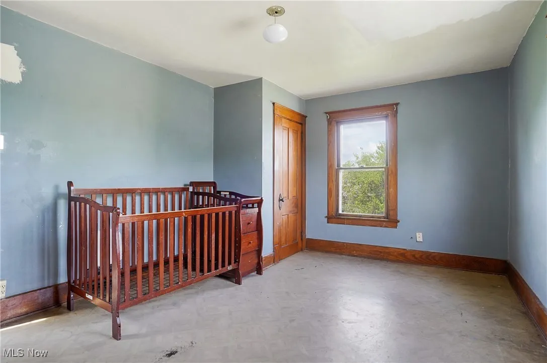 Bedroom with baseboards and a closet