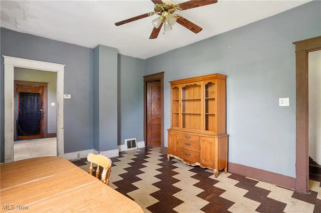 Dining space featuring tile patterned floors and ceiling fan