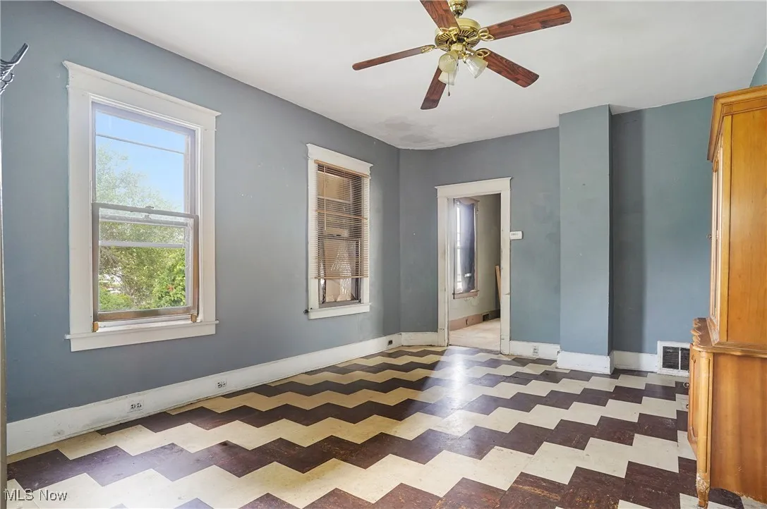 Spare room featuring light floors and ceiling fan