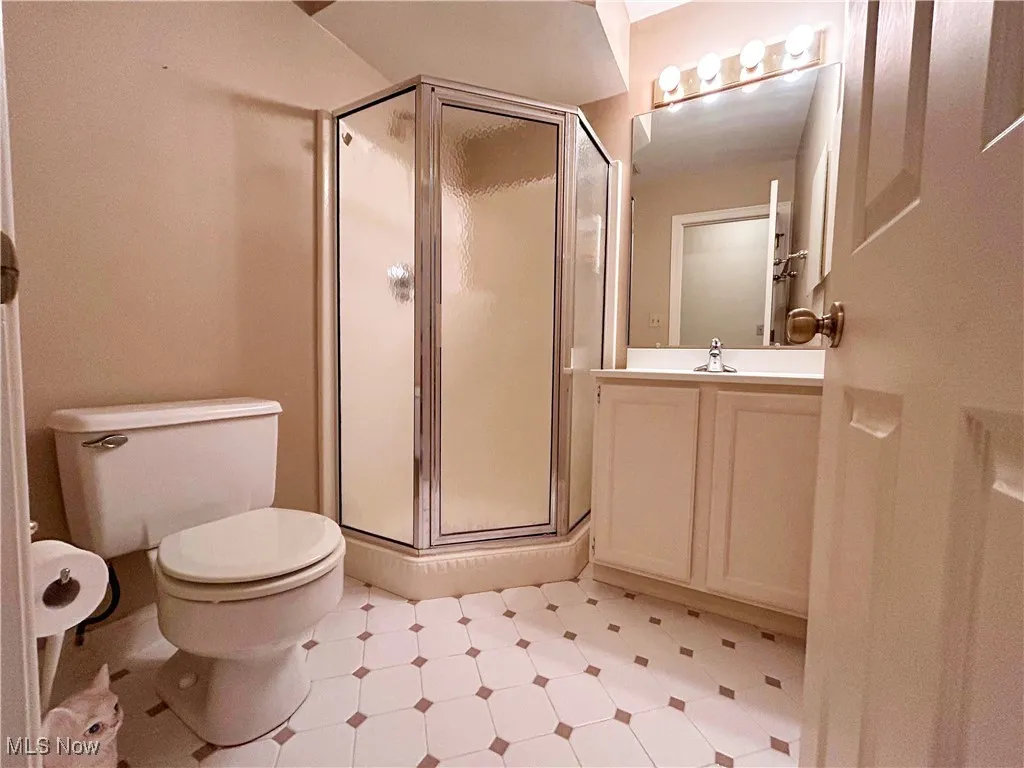 Second floor full bathroom featuring vanity, toilet, a shower stall, and tile patterned floors