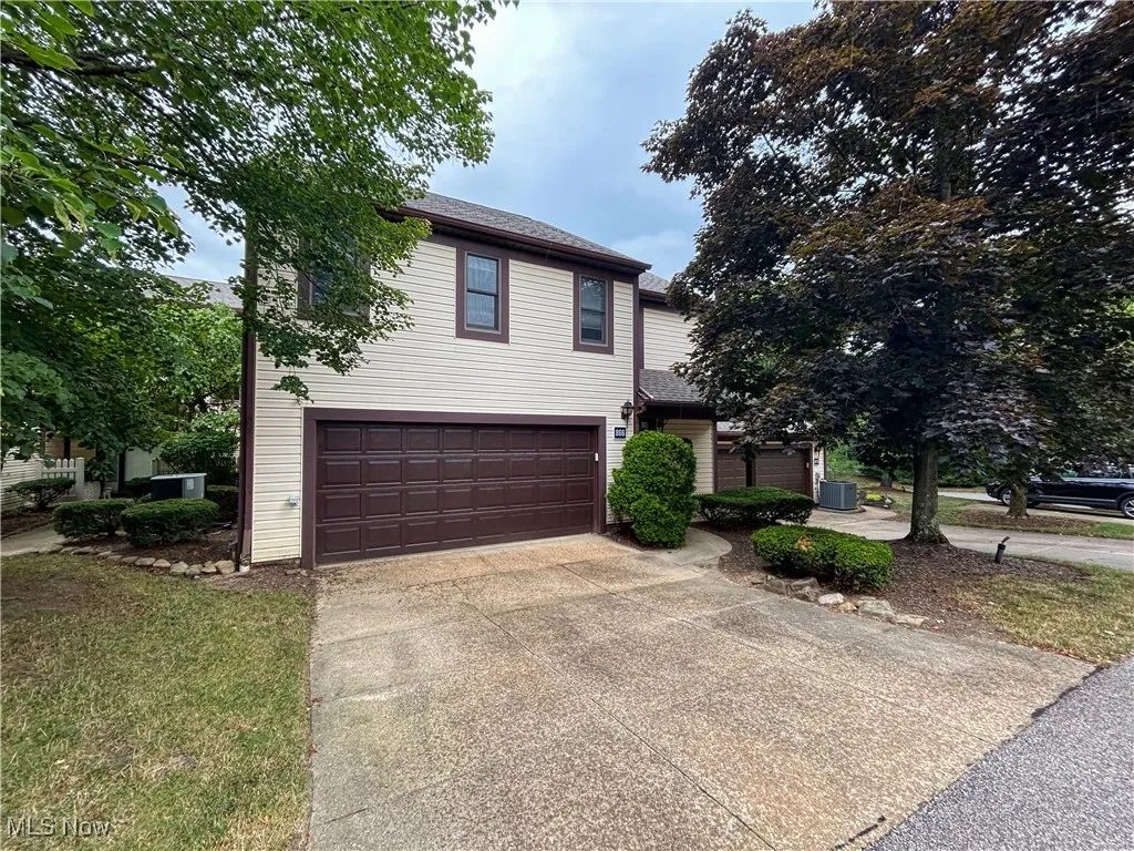 View of front facade with driveway, and a 2 car, garage.