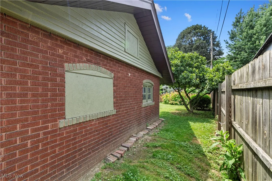 View of side of home with brick siding