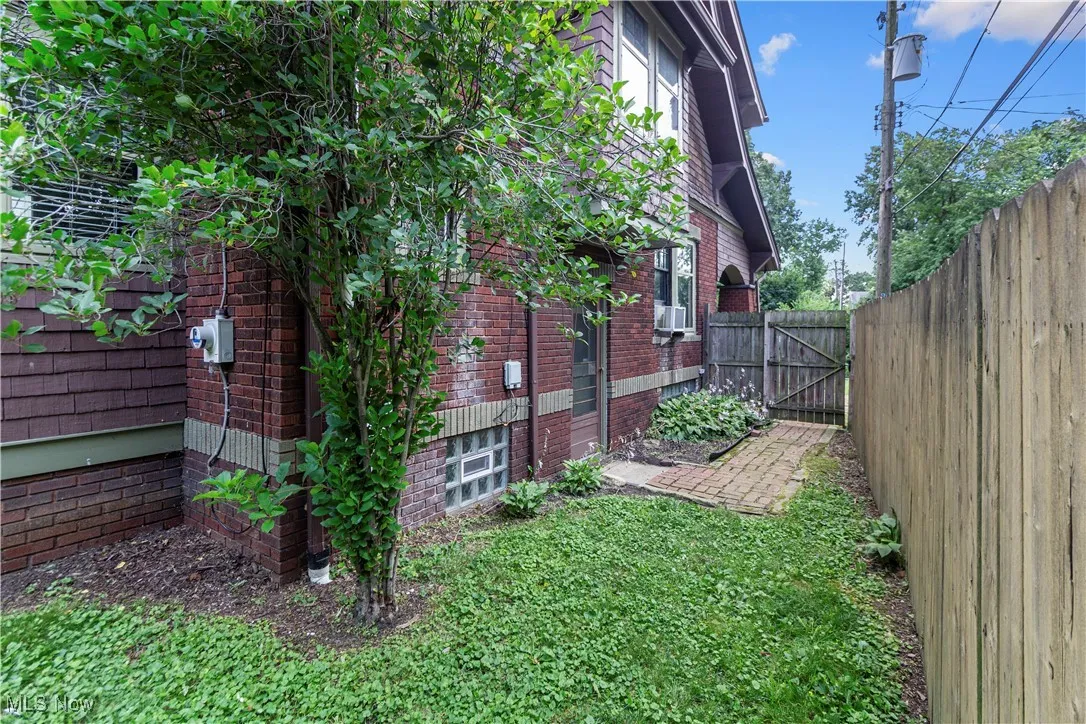 View of side of home with a gate