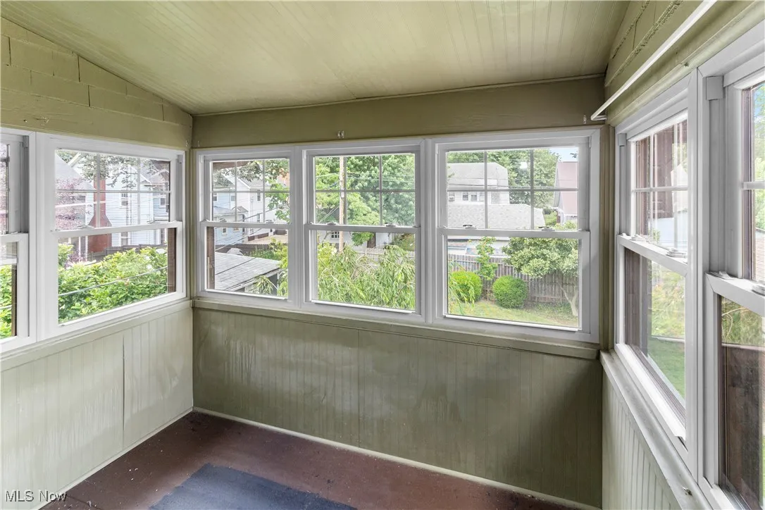 Unfurnished sunroom with vaulted ceiling and healthy amount of natural light