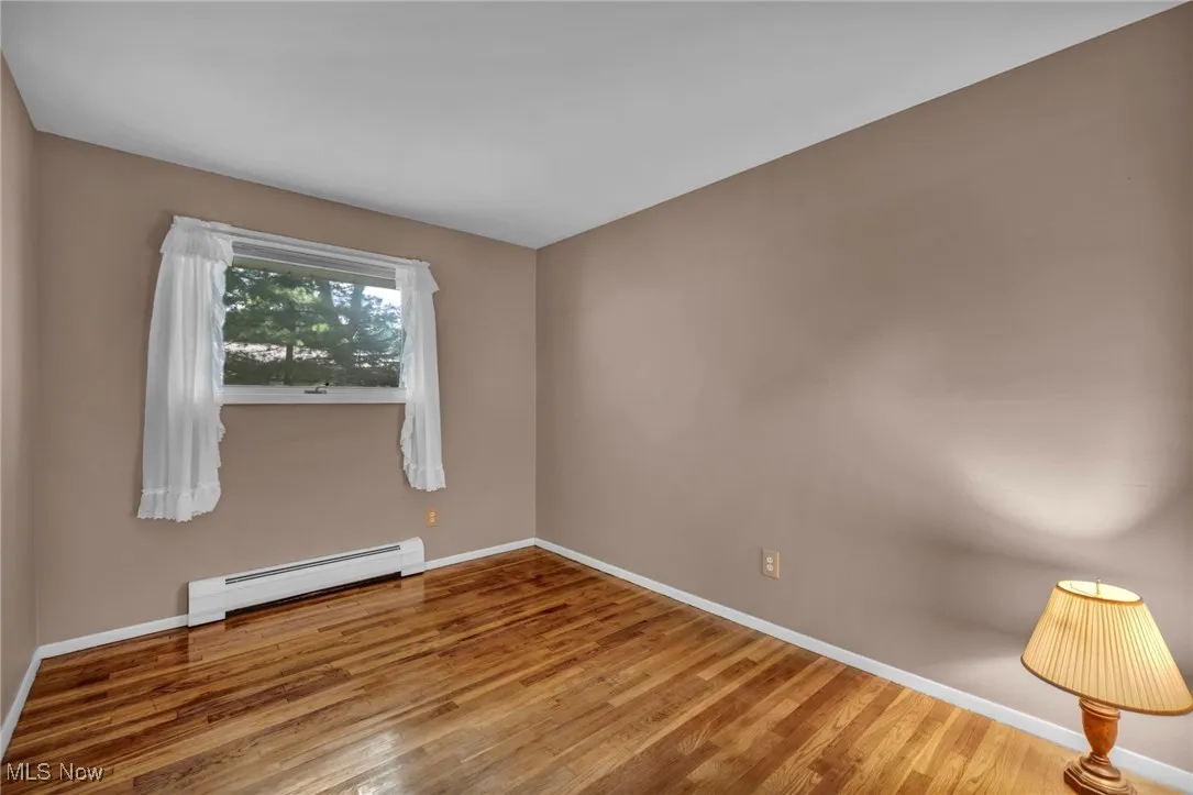 third bedroom with real hardwood flooring