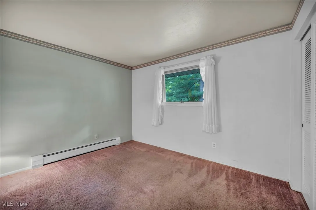 second bedroom with carpeted floor. real hardwood underneath