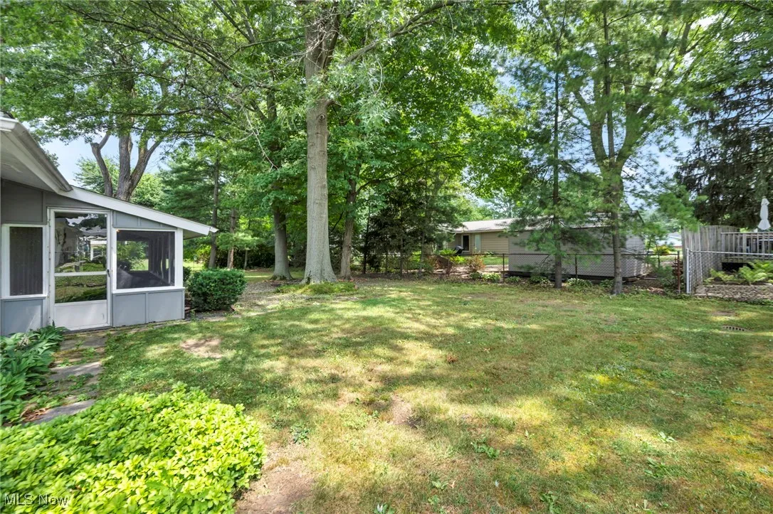 View of yard featuring a sunroom