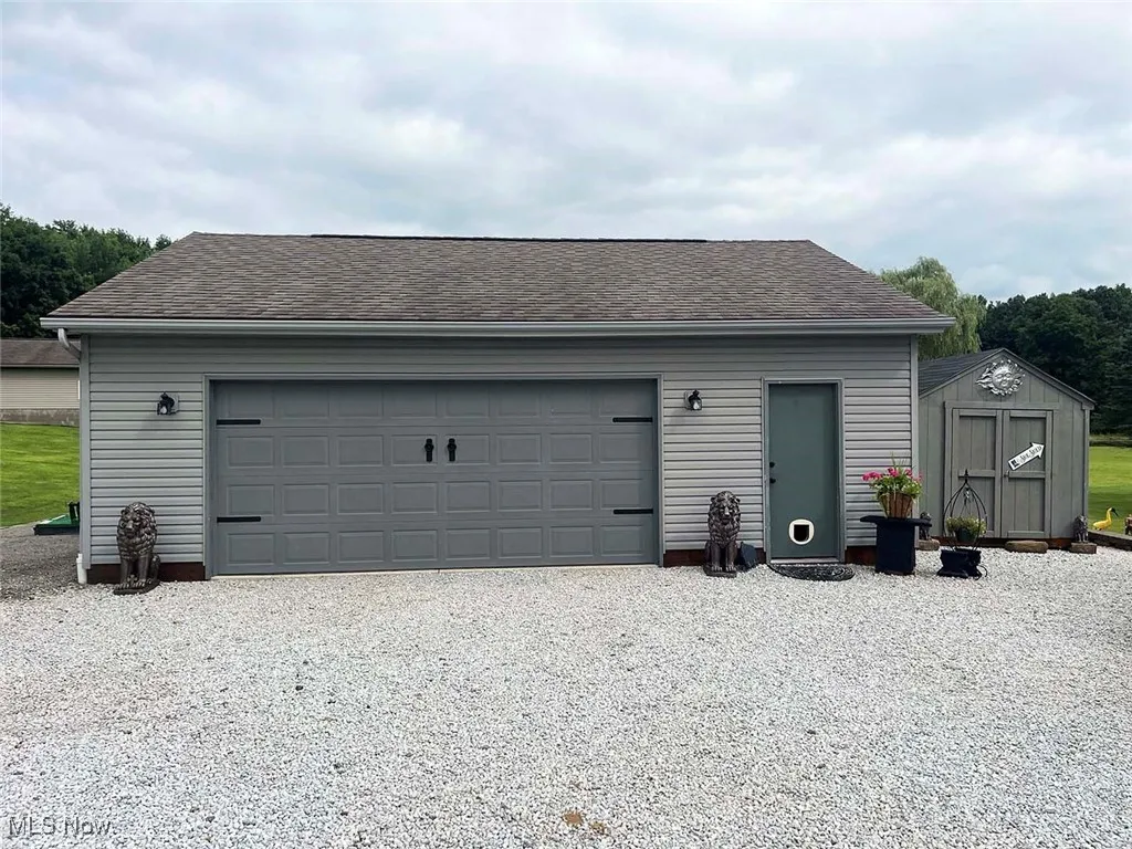 Garage featuring a shed