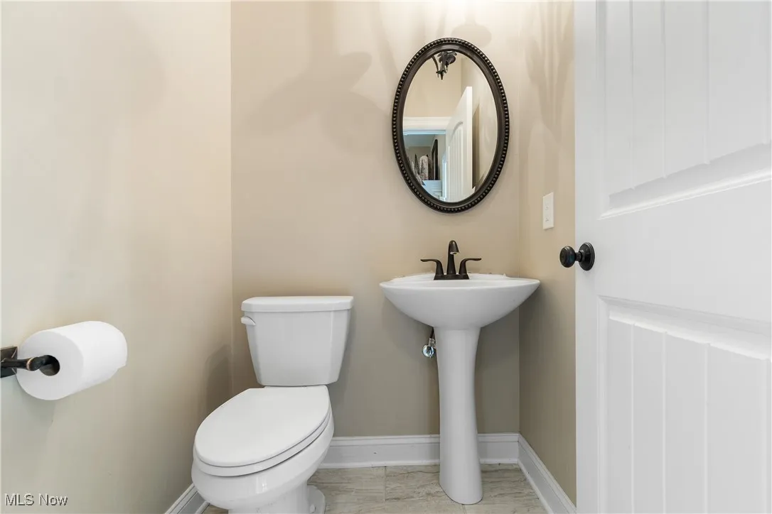 Bathroom with toilet and baseboards