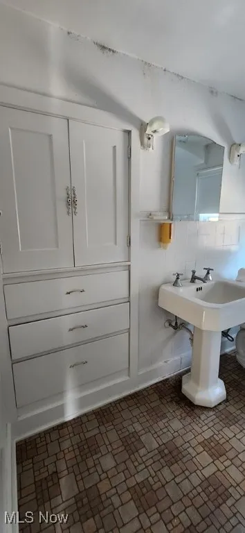 Bathroom with brick patterned flooring
