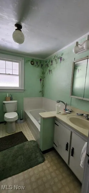 Bathroom featuring vanity, a bath, and tile patterned floors