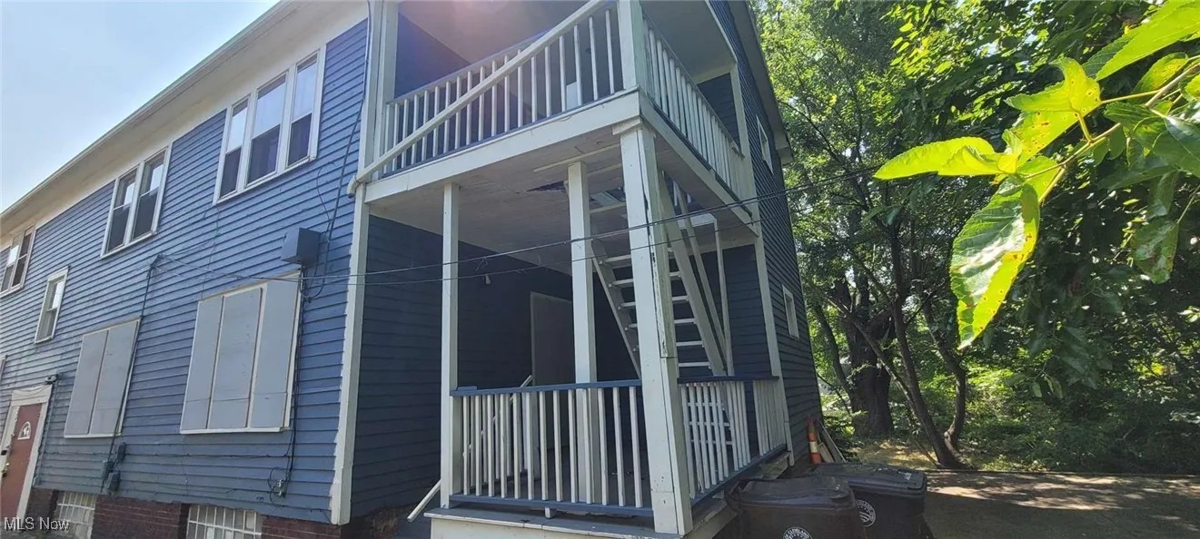 View of side of home with a balcony