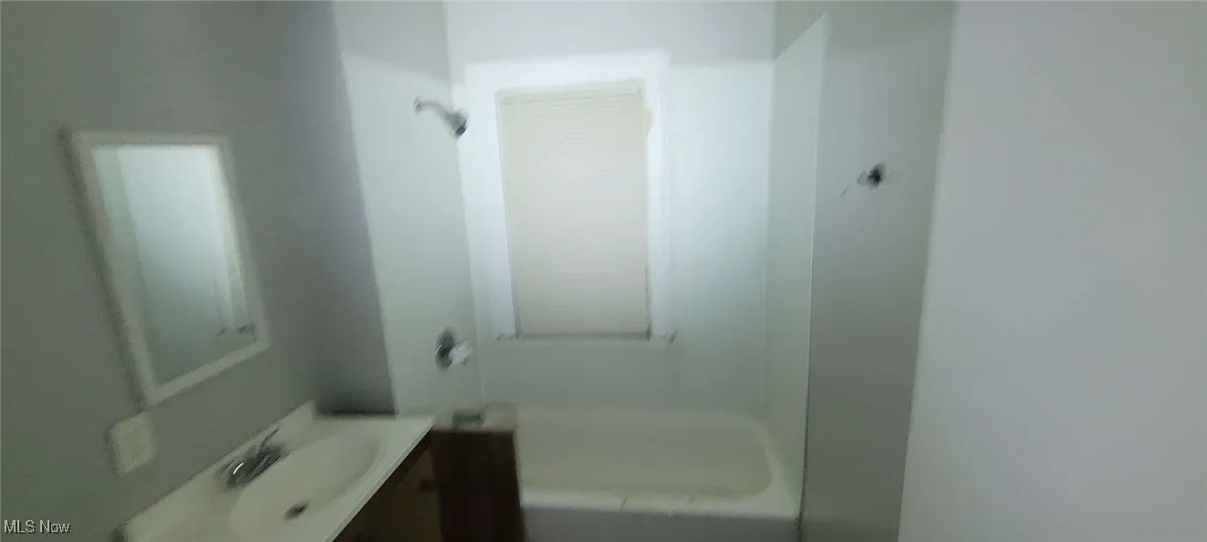 Full bathroom with vanity and bathtub / shower combination