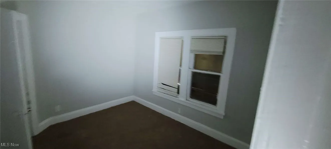 Unfurnished room with baseboards