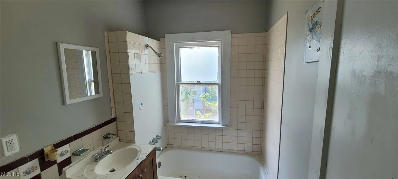 Full bathroom featuring a tub to relax in and vanity