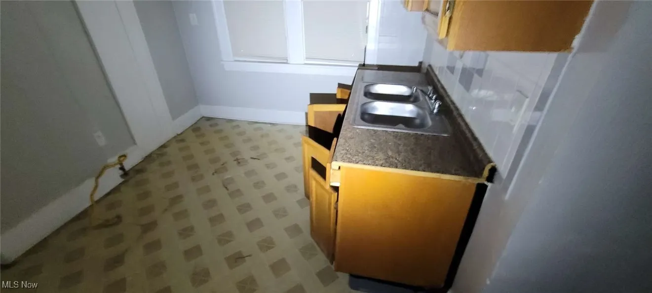 Kitchen with light flooring and a sink