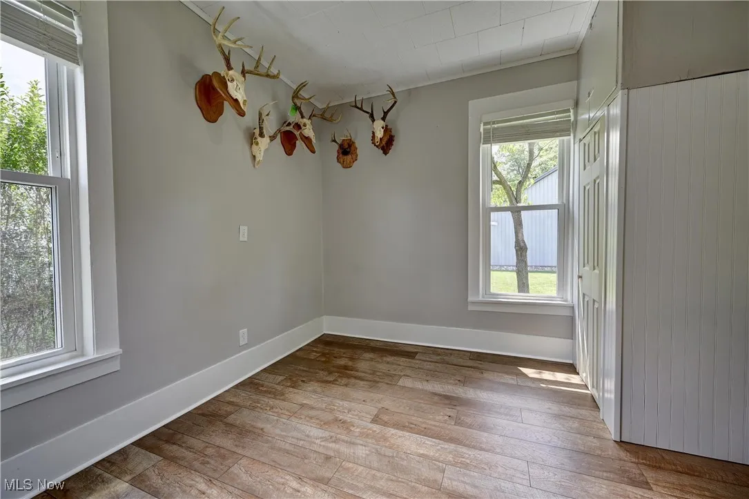 Spare room with hardwood / wood-style flooring and baseboards