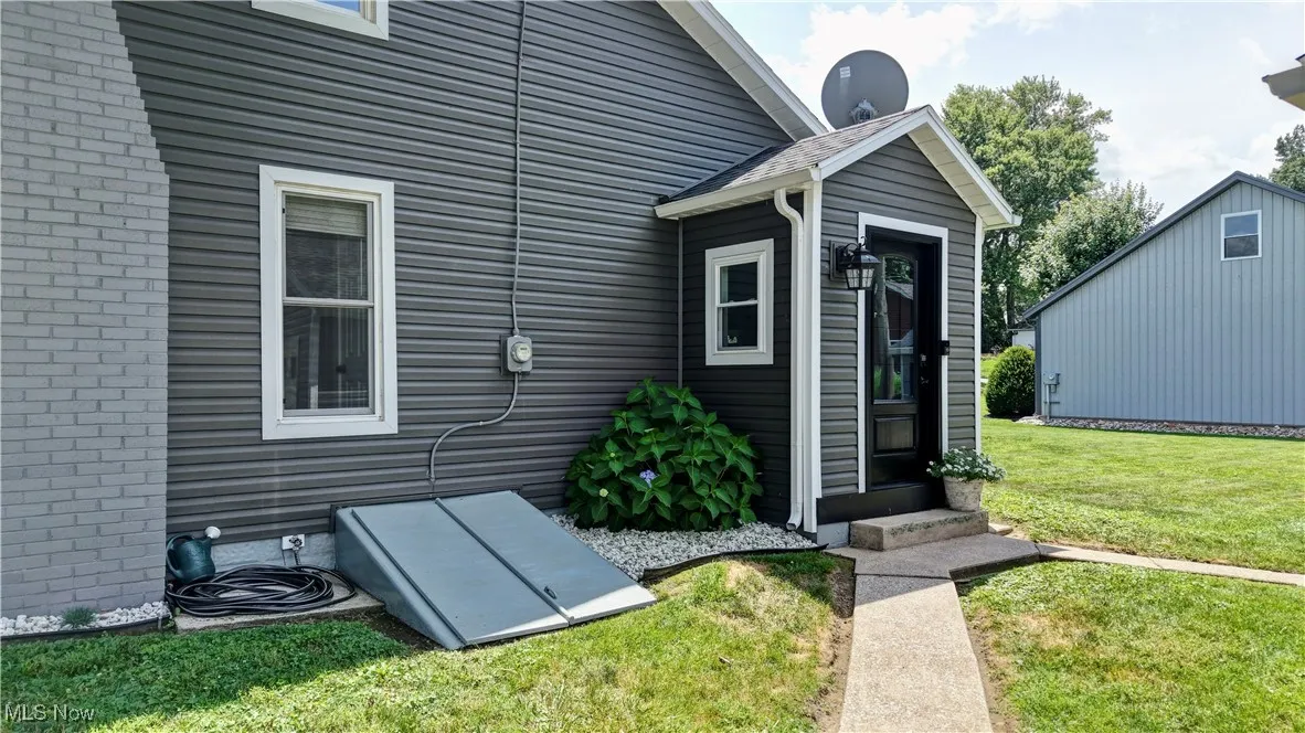 Entrance to property featuring a lawn