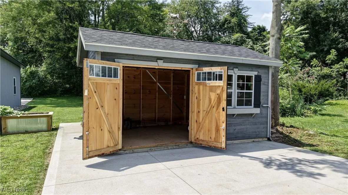 View of outdoor structure with view of wooded area