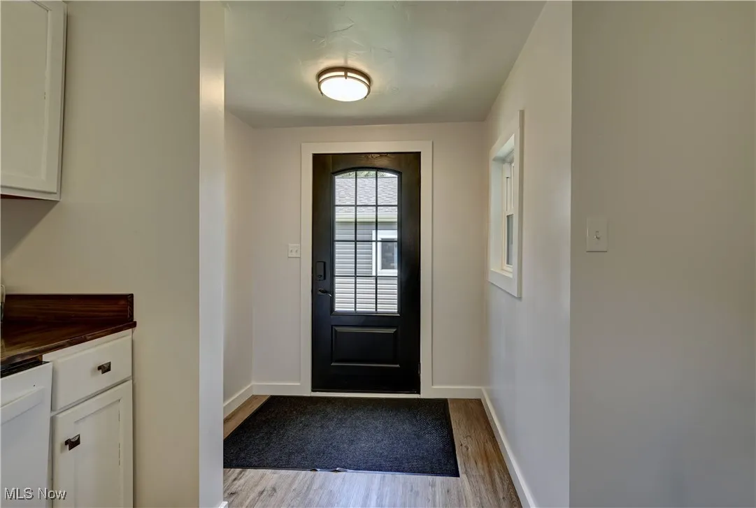 Entryway featuring wood finished floors and baseboards