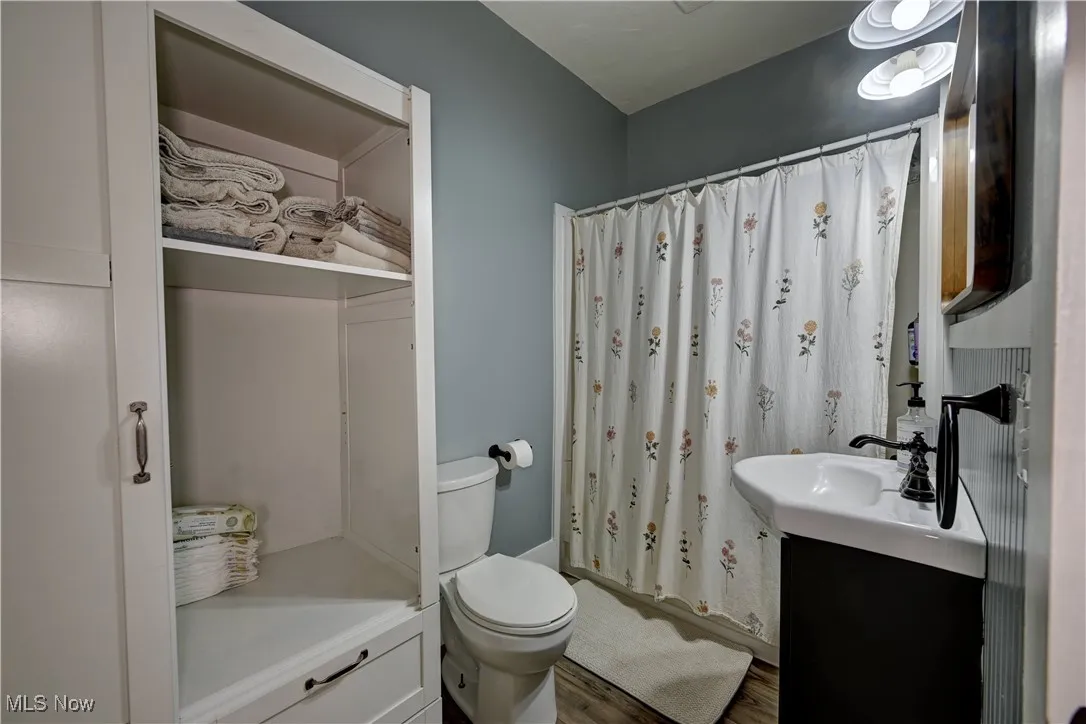 Bathroom with vanity and wood finished floors