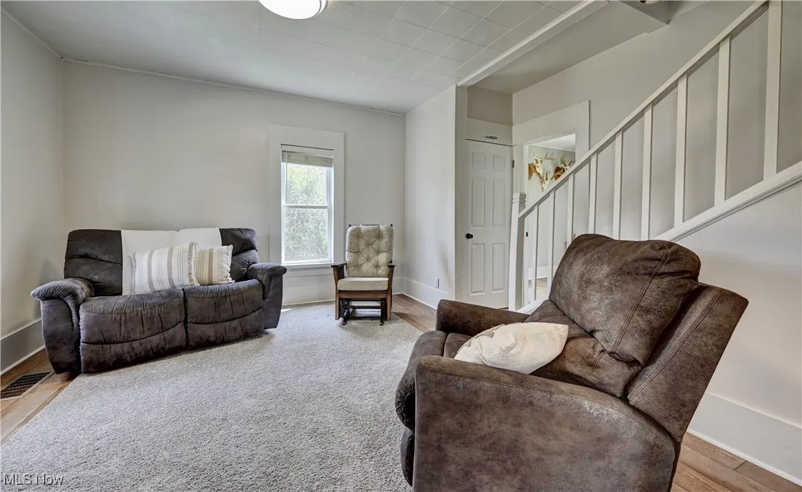 Living area with stairs and wood finished floors