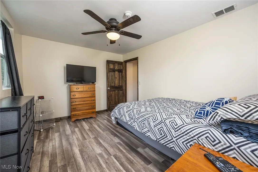 Bedroom with wood finished floors and ceiling fan