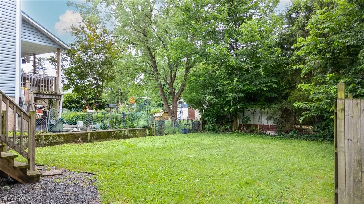 Fenced backyard with stairs