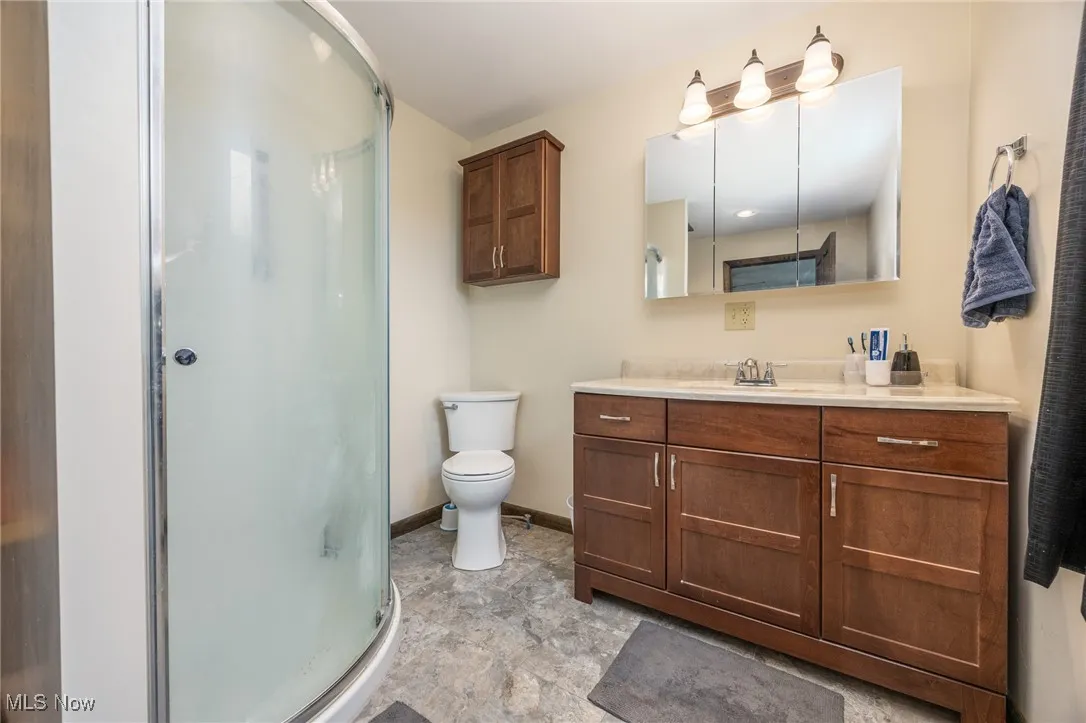 Bathroom featuring vanity and a shower stall